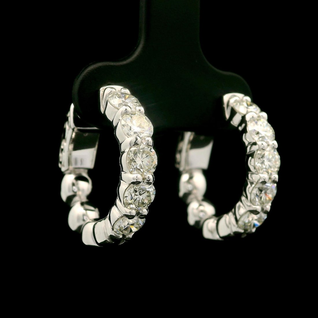 14k White Gold 2.01ctw Diamond Huggie Hoop Earrings: 14k White Gold 2.01ctw Diamond Huggie Hoop Earrings These stunning huggie hoop earrings are crafted from solid 14k yellow gold and feature a total carat weight of 2.01ctw, showcasing 10 round brillian