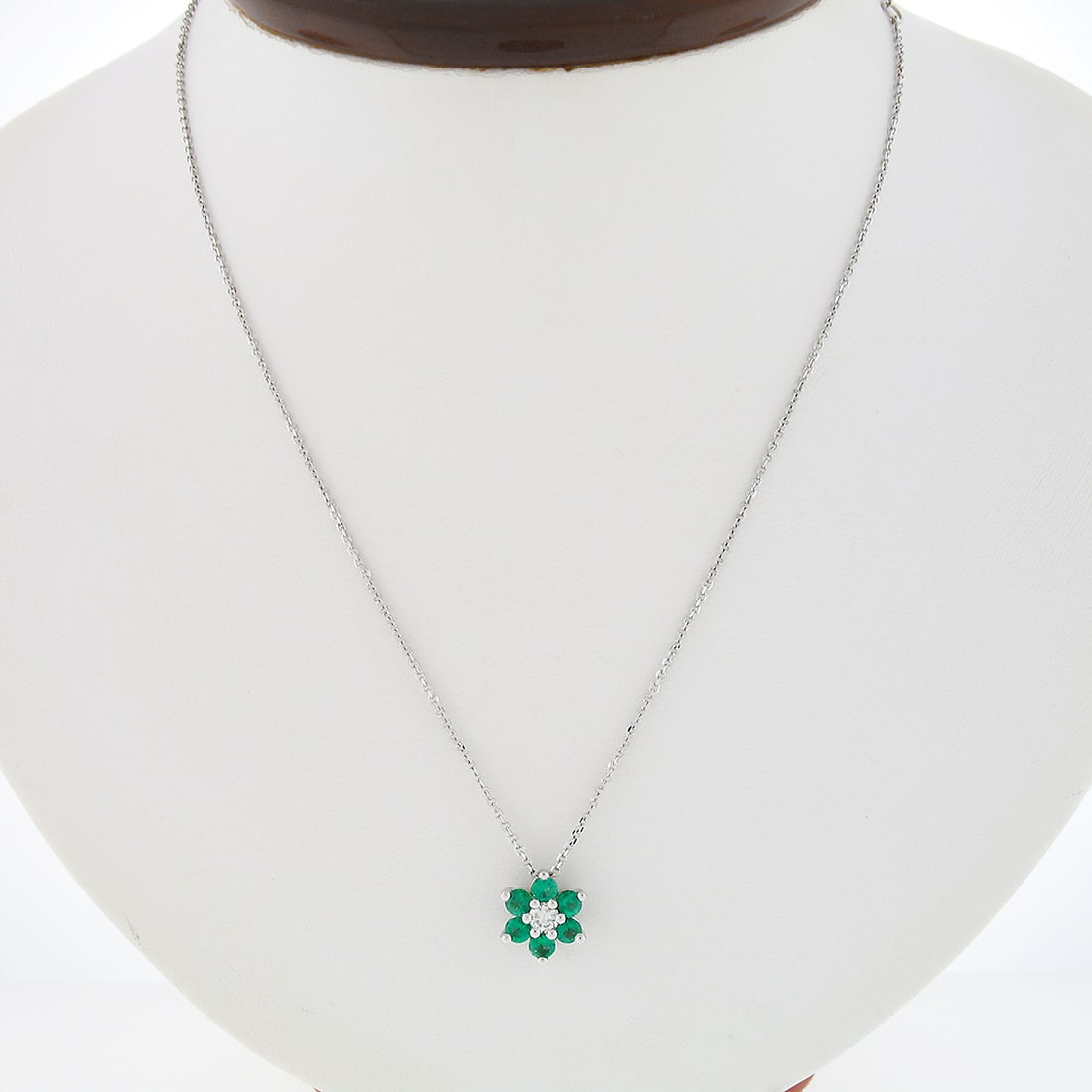 14k White Gold 0.83ct Diamond Emerald Flower Pendant Necklace: 14k White Gold 0.83ct Diamond Emerald Flower Pendant Necklace This stunning flower cluster pendant necklace is crafted from solid 14k white gold and features a captivating design. The centerpiece is a