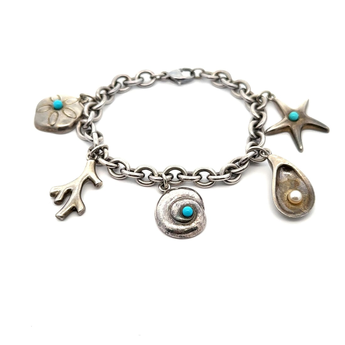 Tiffany & Co. Silver Sea Life Charm Bracelet with Turquoise and Pearl: Tiffany & Co. Silver Sea Life Charm Bracelet with Turquoise and Pearl This exquisite Tiffany & Co. Silver Turquoise & Pearl Sea Life Charm Link Bracelet is a stunning piece perfect for ocean lovers. T