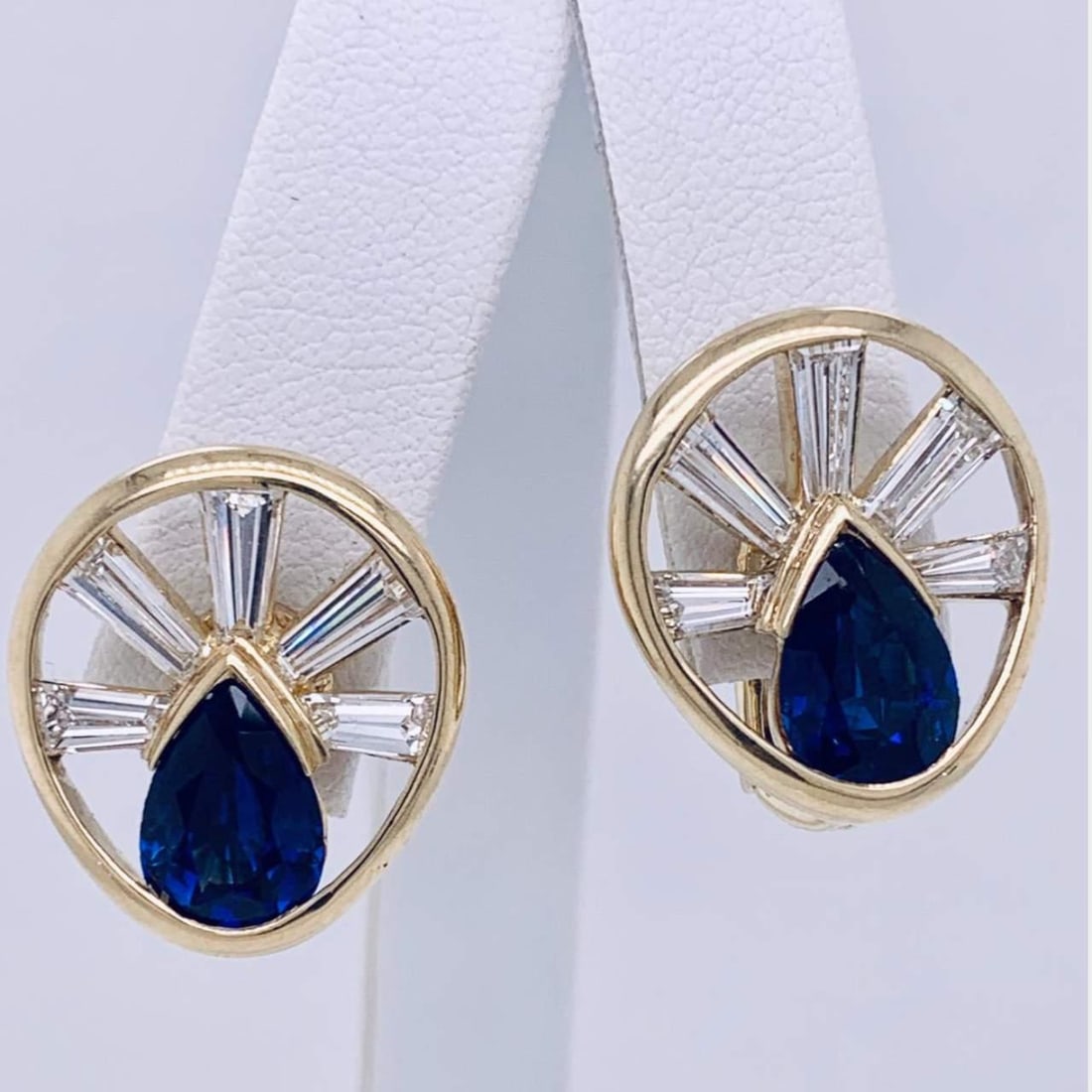 Elegant 18K Yellow Gold Sapphire Diamond Earrings 10 Diamonds 2 Sapphires: Elegant 18K Yellow Gold Sapphire Diamond Earrings 10 Diamonds 2 Sapphires These stunning Sapphire and Diamond Earrings feature a luxurious design, showcasing 10 sparkling diamonds that weigh approxima