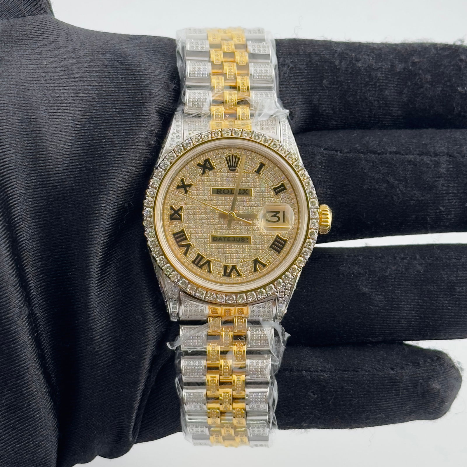 Iced Out Aftermarket Jubilee Bracelet Rolex Datejust Roman Dial Ref 1601: Iced Out Aftermarket Jubilee Bracelet Rolex Datejust Roman Dial Ref 1601 This Rolex Datejust features an iced out Roman numeral dial and an aftermarket Jubilee bracelet with an iced out finish. The wa