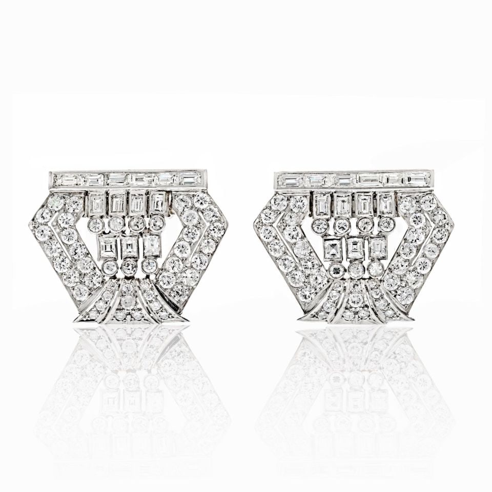 1940s Platinum Double Clip Brooches 8.00ct Diamond Elegance: 1940s Platinum Double Clip Brooches 8.00ct Diamond Elegance This exquisite pair of 1940s double clip brooches is crafted in platinum and adorned with a stunning array of hand-set diamonds totaling