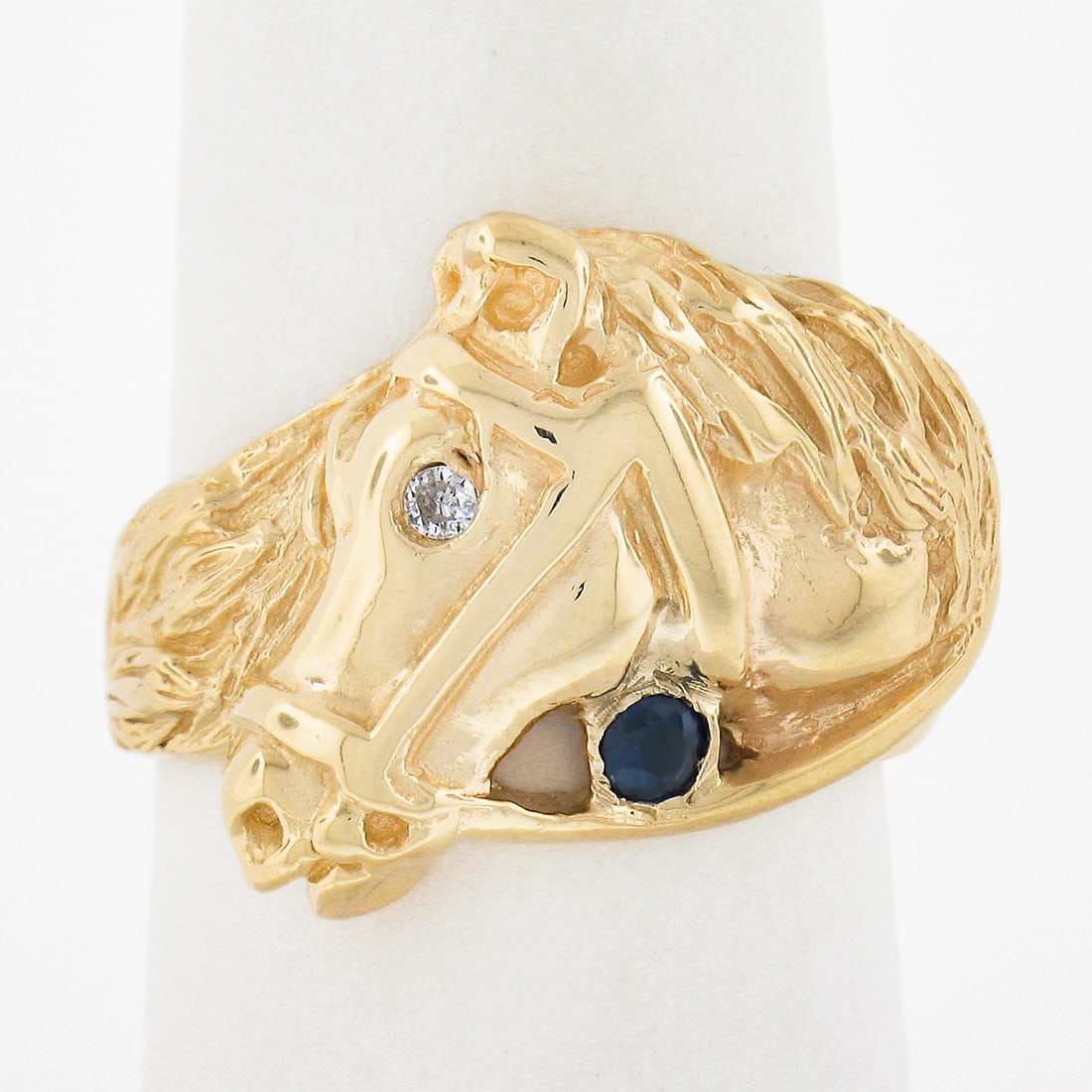 14K Yellow Gold Horse Head Ring with Diamond and Sapphire: 14K Yellow Gold Horse Head Ring with Diamond and Sapphire This exquisite Estate 14K Yellow Gold Detailed Horse Head Band Ring features a captivating design with a flush setting, showcasing a stunning