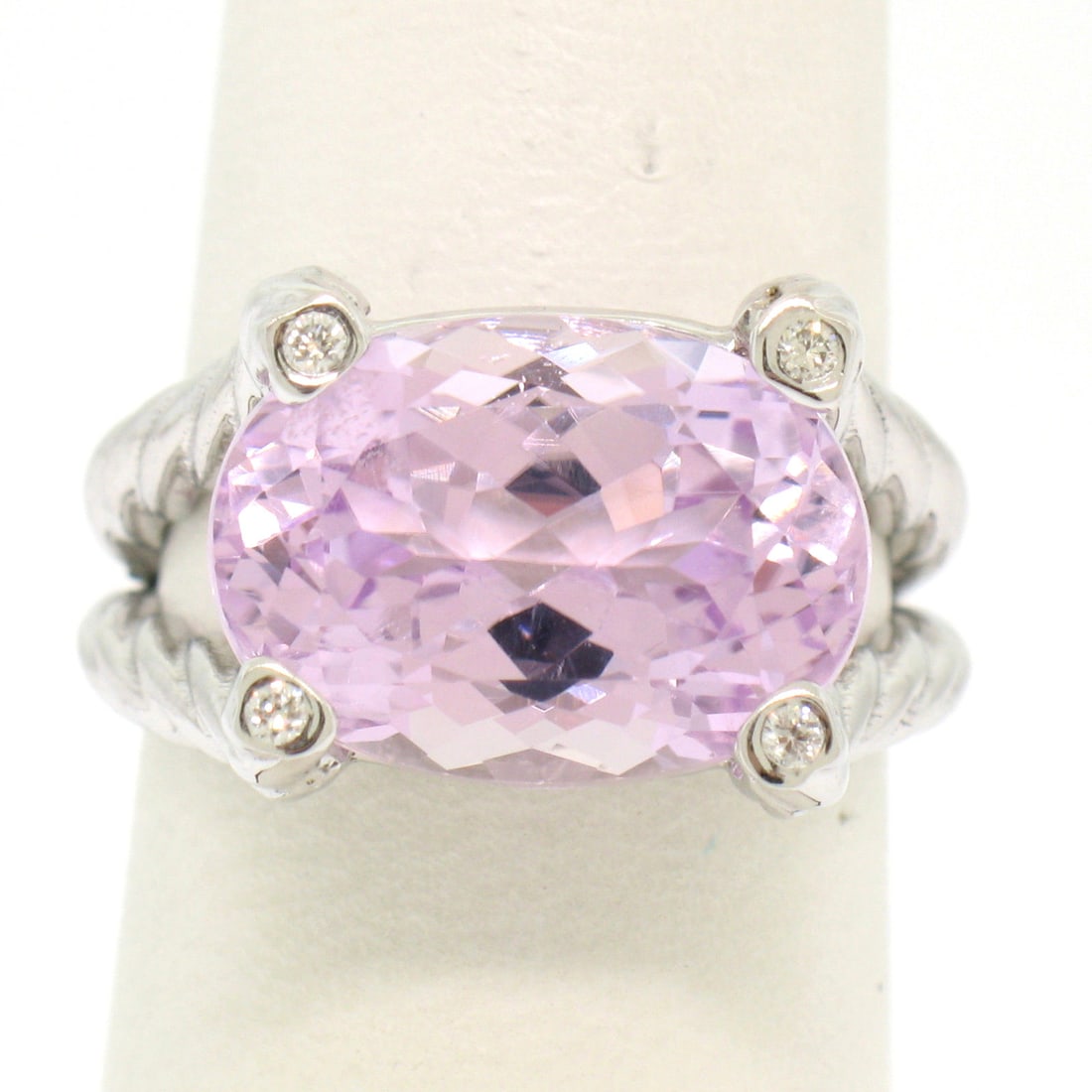 14k White Gold Twisted Cable Kunzite Ring with 4 Diamond Accents: 14k White Gold Twisted Cable Kunzite Ring with 4 Diamond Accents This stunning 14k white gold twisted cable ring features a substantial 8.50ct oval kunzite at its center, showcasing a rich and vivid