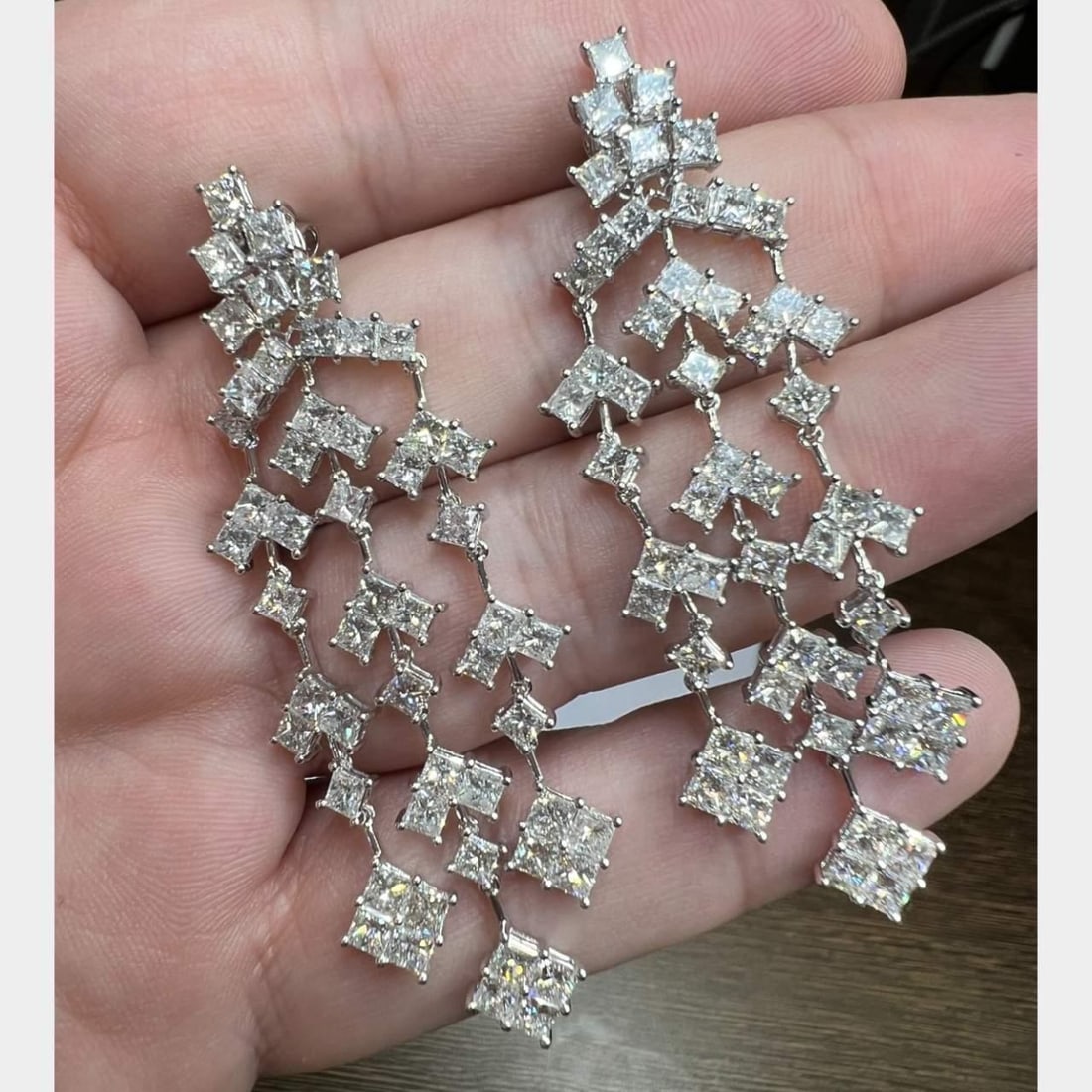 Elegant 18K White Gold 12.12 Ct Diamond Chandelier Earrings: Elegant 18K White Gold 12.12 Ct Diamond Chandelier Earrings Elevate your elegance with these stunning 18K White Gold Chandelier Earrings, adorned with a total of 104 diamonds weighing 12.12 ct. The
