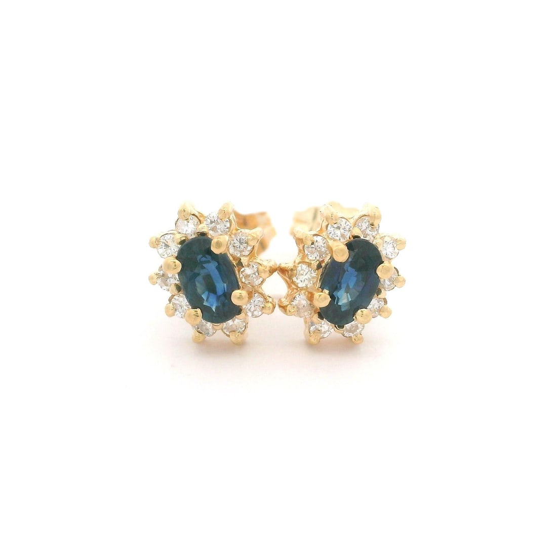 14k Yellow Gold 1ctw Oval Blue Sapphire Diamond Halo Stud Earrings: 14k Yellow Gold 1ctw Oval Blue Sapphire Diamond Halo Stud Earrings Elevate your elegance with these stunning petite stud earrings, crafted from solid 14k yellow gold. Each earring features a captivati