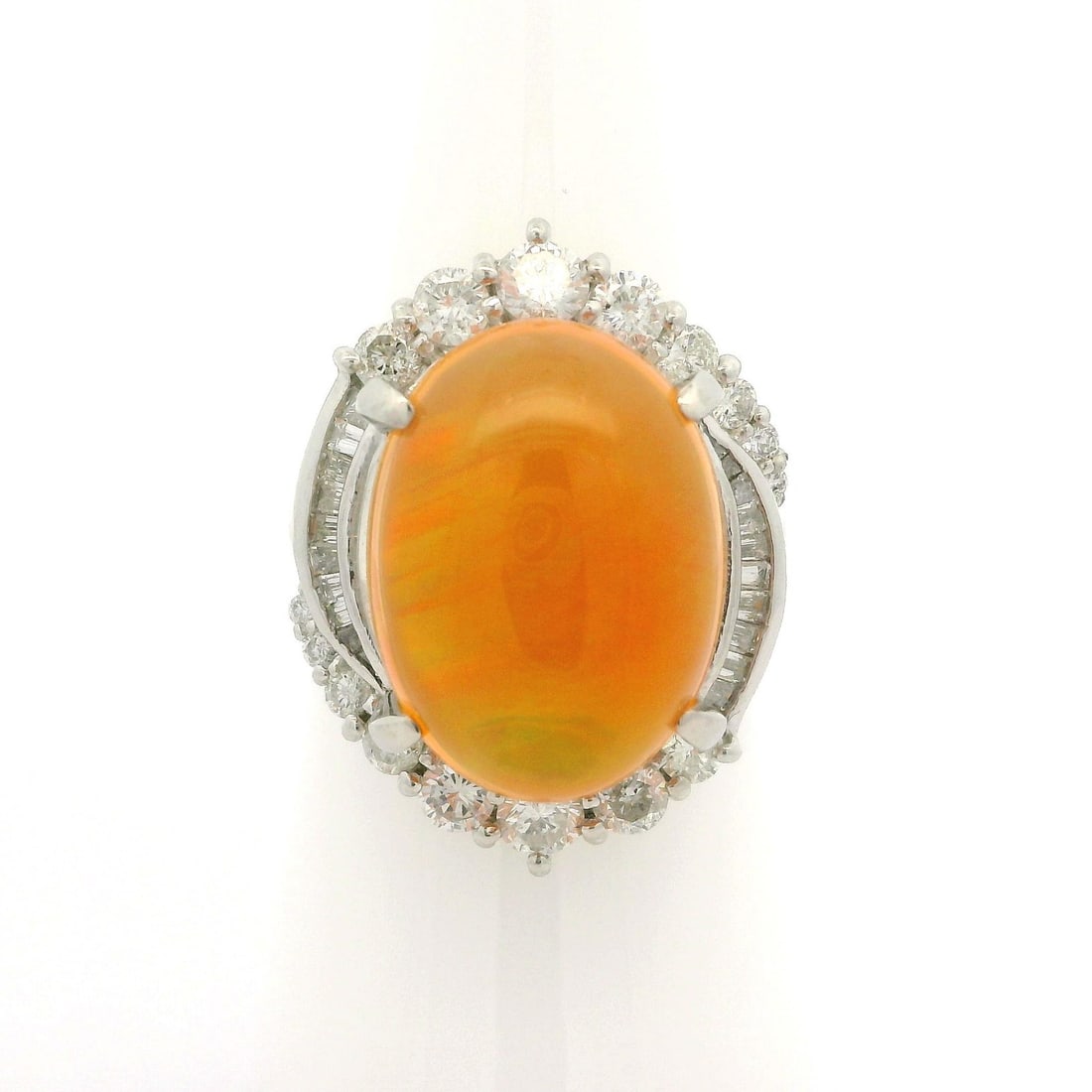 Platinum 11.05ctw Orange Jelly Opal Diamond Halo Cocktail Ring: Platinum 11.05ctw Orange Jelly Opal Diamond Halo Cocktail Ring This stunning cocktail ring features a large, natural jelly opal at its center, showcasing a fiery orange hue with exceptional play of co