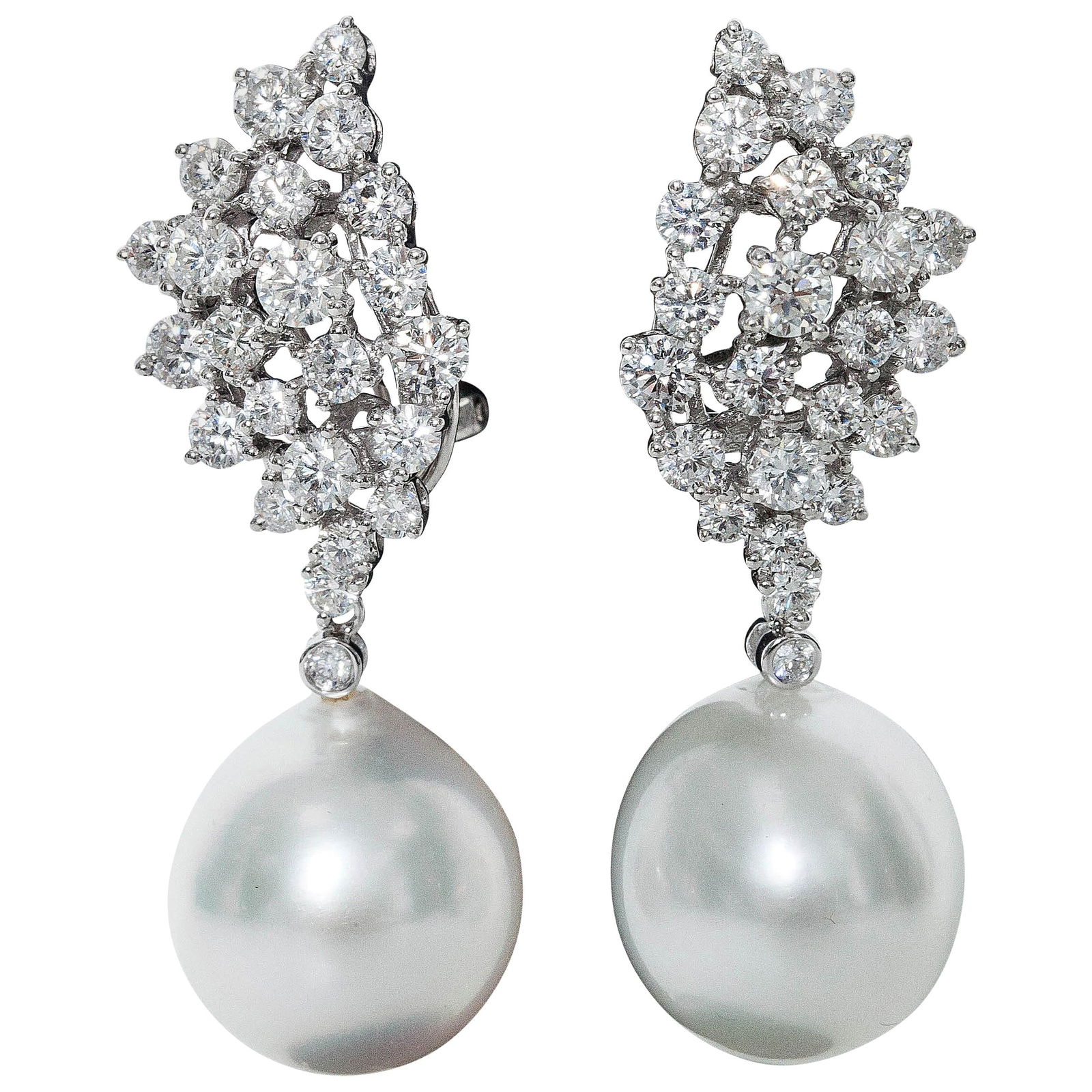 South Sea Pearl and Diamond Drop Earrings in 18K White Gold 2.7 CT 13-14mm: South Sea Pearl and Diamond Drop Earrings in 18K White Gold 2.7 CT 13-14mm These contemporary drop earrings feature South Sea cultured pearls paired with a cluster of round-cut diamonds set in 18K whi
