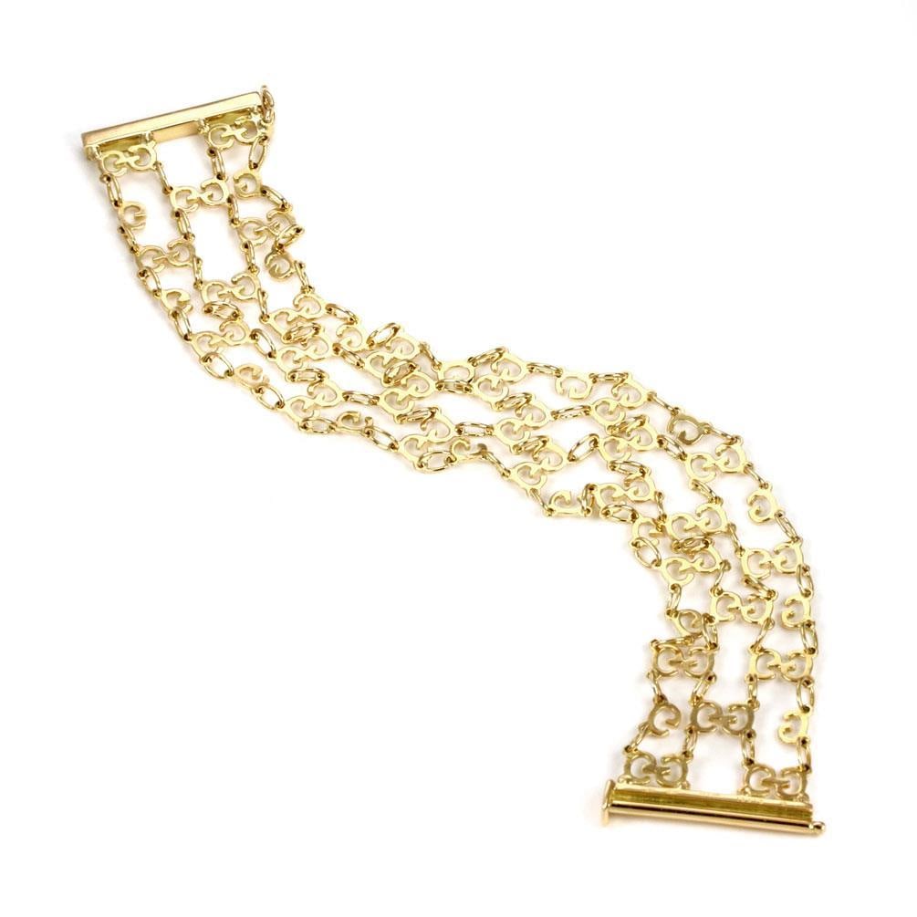 Gucci 18k Yellow Gold G Logo 4 Strand Bracelet 6.5": Gucci 18k Yellow Gold G Logo 4 Strand Bracelet 6.5" This exquisite bracelet from Gucci's G logo collection is a stunning piece crafted from 18k yellow gold. The bracelet features a polished finish and
