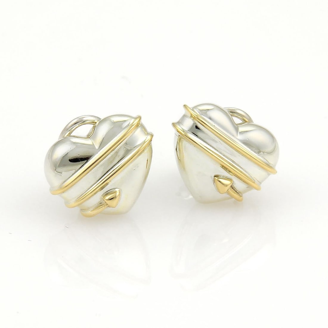 Tiffany & Co. Cupid's Arrow Heart Earrings Sterling Silver 18k Gold Clip-On: Tiffany & Co. Cupid's Arrow Heart Earrings Sterling Silver 18k Gold Clip-On Discover a charming addition to your jewelry collection with these Tiffany & Co. Cupid's Arrow Heart Earrings. Crafted from