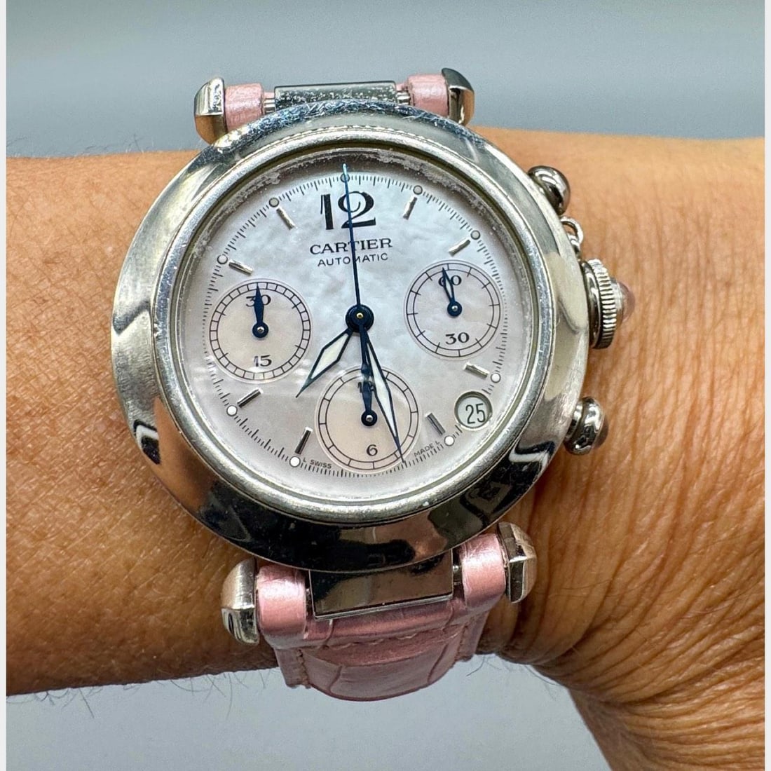 CARTIER Pasha 35mm Stainless Steel Automatic with Mother of Pearl Dial: CARTIER Pasha 35mm Stainless Steel Automatic with Mother of Pearl Dial Introducing the Cartier Stainless Steel 35mm Pasha, a stunning timepiece that combines elegance with functionality. This exquisit