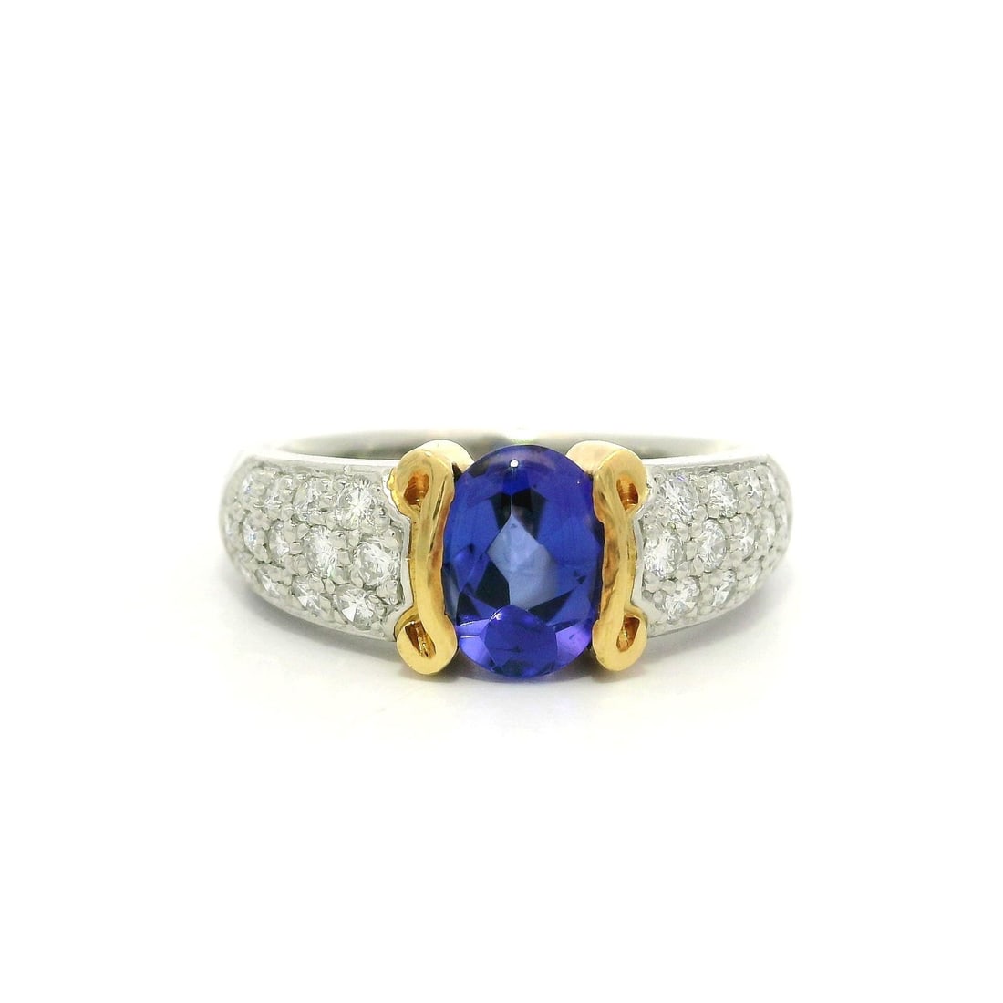 Platinum 1.99ctw Oval Buff Top Tanzanite and Diamond Band Ring: Platinum 1.99ctw Oval Buff Top Tanzanite and Diamond Band Ring This stunning band ring features a high-quality natural oval cut tanzanite, showcasing a beautiful violet blue color. The tanzanite measu