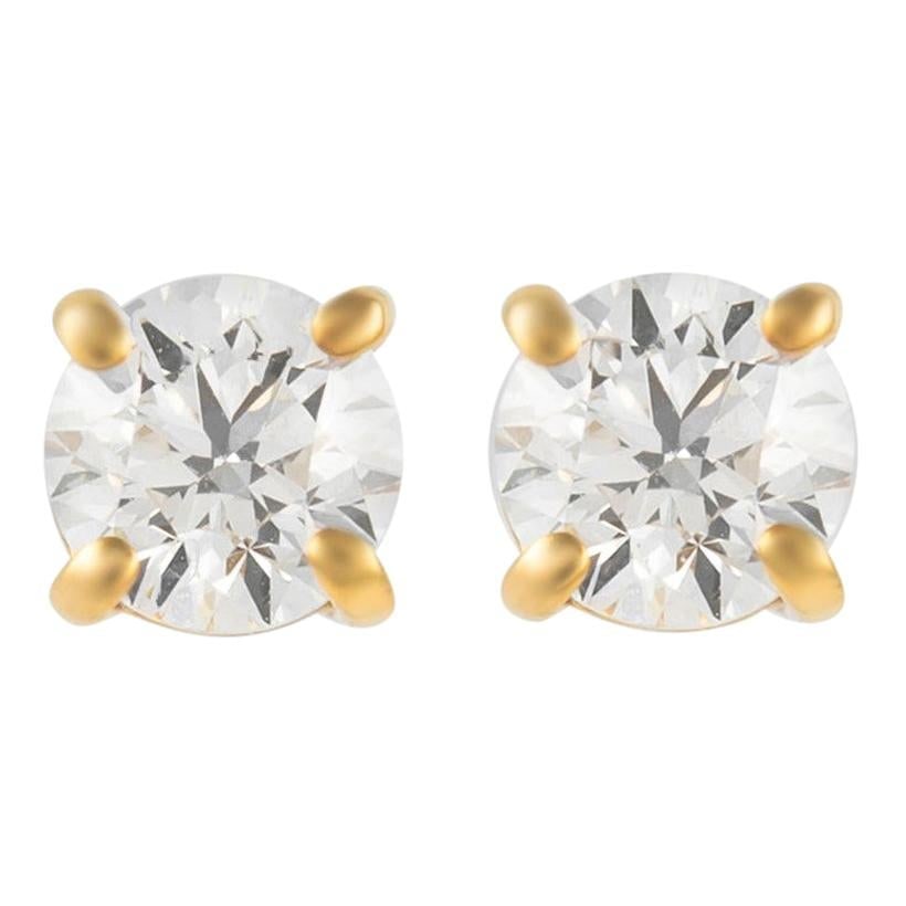 0.92 Carat Diamond Stud Earrings in 14k Yellow Gold: 0.92 Carat Diamond Stud Earrings in 14k Yellow Gold Elevate your elegance with these stunning diamond stud earrings, crafted from 14k yellow gold. Featuring two round brilliant diamonds totaling 0.92