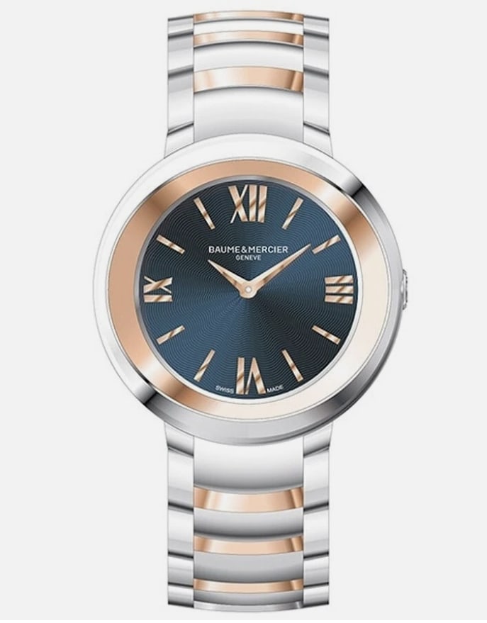 Promesse Blue Face Watch M0A10251 34mm with Warranty Card 2024: Promesse Blue Face Watch M0A10251 34mm with Warranty Card 2024 This Baume & Mercier Promesse wristwatch features a blue dial and a 34mm case crafted from stainless steel with rose gold capping. The wa