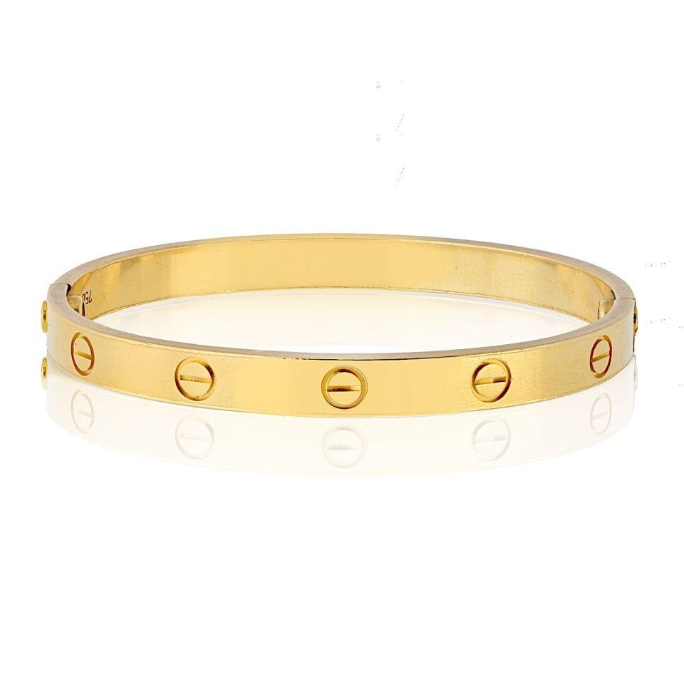 Cartier Love Bracelet 18K Yellow Gold Size 17 with Screwdriver: Cartier Love Bracelet 18K Yellow Gold Size 17 with Screwdriver This pre-owned Cartier Love Bracelet, crafted from 18K Yellow Gold and sized at 17, is a timeless symbol of elegance and commitment. It f