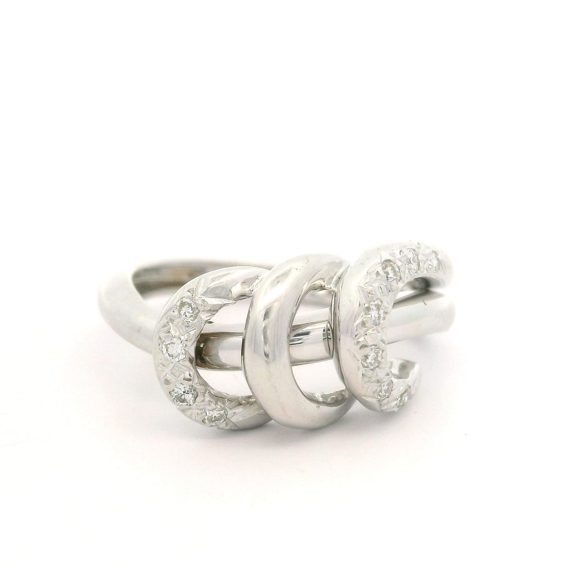 18k White Gold Abstract Ring with 0.11ctw Diamonds: 18k White Gold Abstract Ring with 0.11ctw Diamonds This exquisite cocktail ring features a striking abstract design crafted from solid 18k white gold. It showcases a total carat weight of approximatel