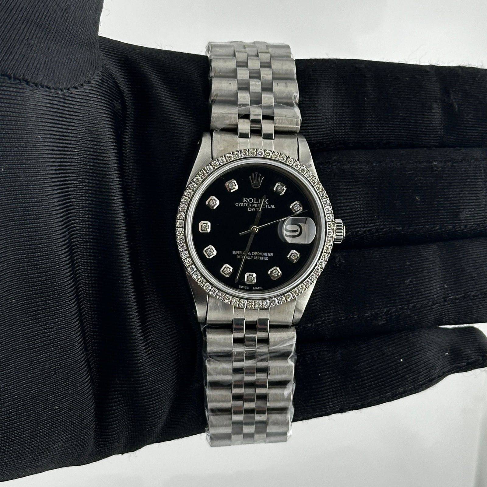 Ref 6694 Aftermarket Black Diamond Dial Unisex Rolex Oyster Perpetual Date Watch: Ref 6694 Aftermarket Black Diamond Dial Unisex Rolex Oyster Perpetual Date Watch This Rolex Oyster Perpetual Date wristwatch features a black diamond aftermarket dial and a prong-set diamond aftermark