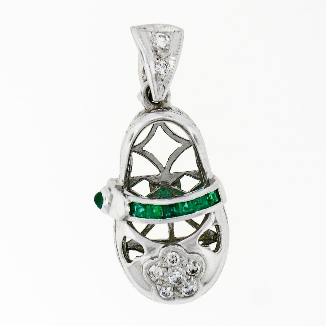 18K White Gold Baby Girl Shoe Pendant with Emerald and Diamond Accents: 18K White Gold Baby Girl Shoe Pendant with Emerald and Diamond Accents This exquisite pendant is crafted from solid 18K white gold and features a charming baby girl shoe design. It is adorned with six