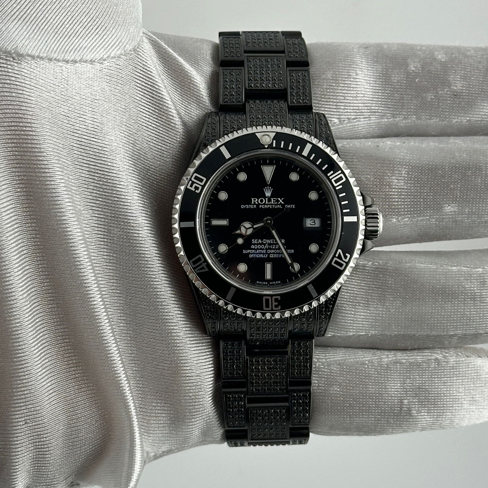 Sea Dweller Ref 16600 Black Dial Oyster Iced Out Men's Watch: Sea Dweller Ref 16600 Black Dial Oyster Iced Out Men's Watch This Rolex Sea Dweller features a striking black dial and an aluminum bezel, presented on an Oyster bracelet that is fully iced out. Design