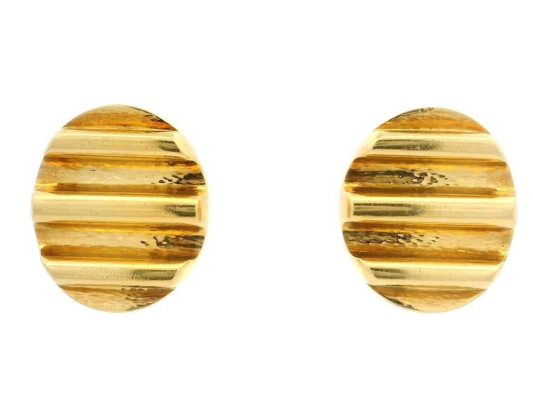 Andrew Clunn 18k Yellow Gold Dual Finish Oval Clip On Earrings: Andrew Clunn 18k Yellow Gold Dual Finish Oval Clip On Earrings These exquisite clip-on earrings by Andrew Clunn are crafted from solid 18k yellow gold, featuring a unique ridged and grooved design com