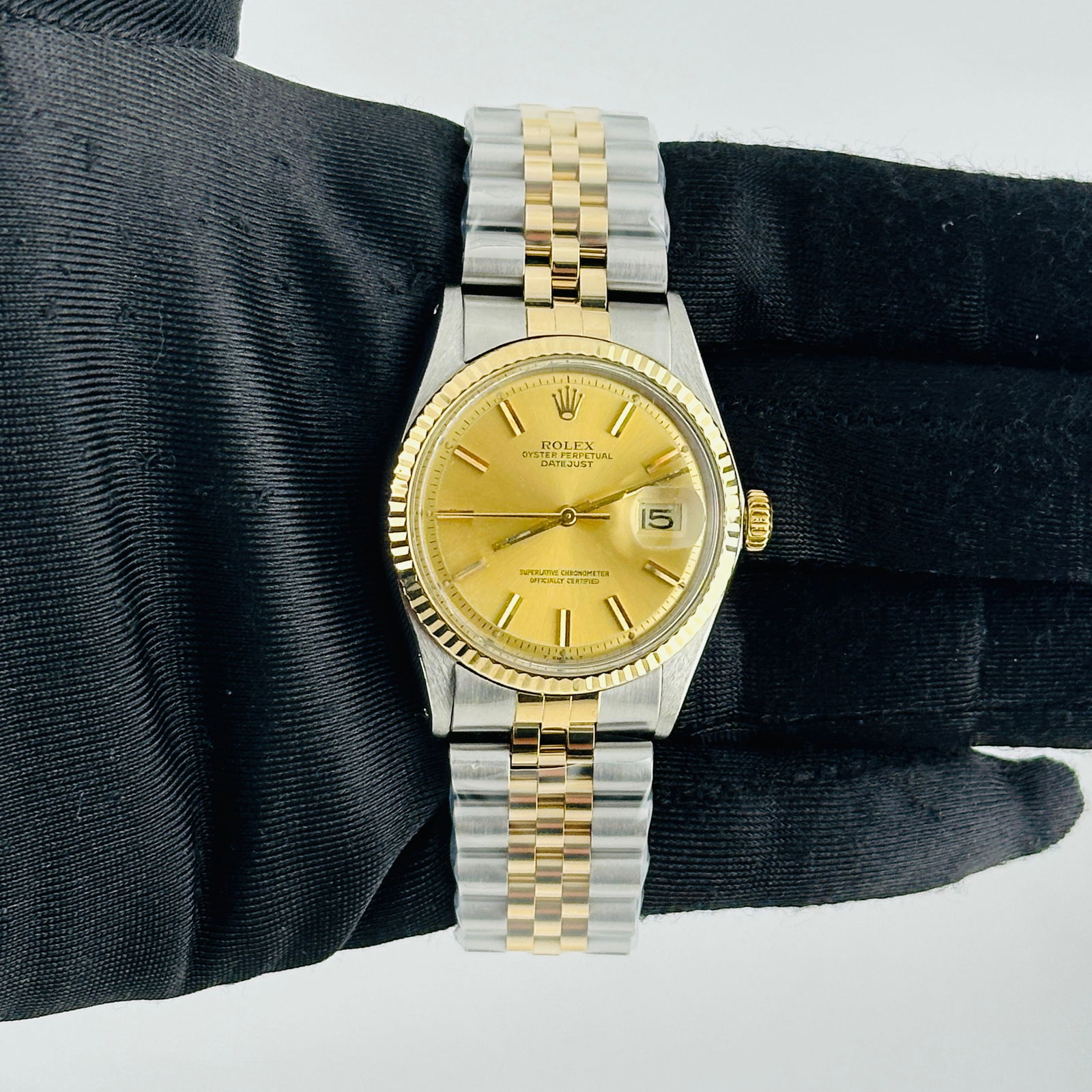 1601 Datejust Champagne Stick Dial Watch with Aftermarket Jubilee Bracelet: 1601 Datejust Champagne Stick Dial Watch with Aftermarket Jubilee Bracelet This Rolex Datejust features a champagne stick dial and a fluted bezel, complemented by an aftermarket Jubilee bracelet. Desi
