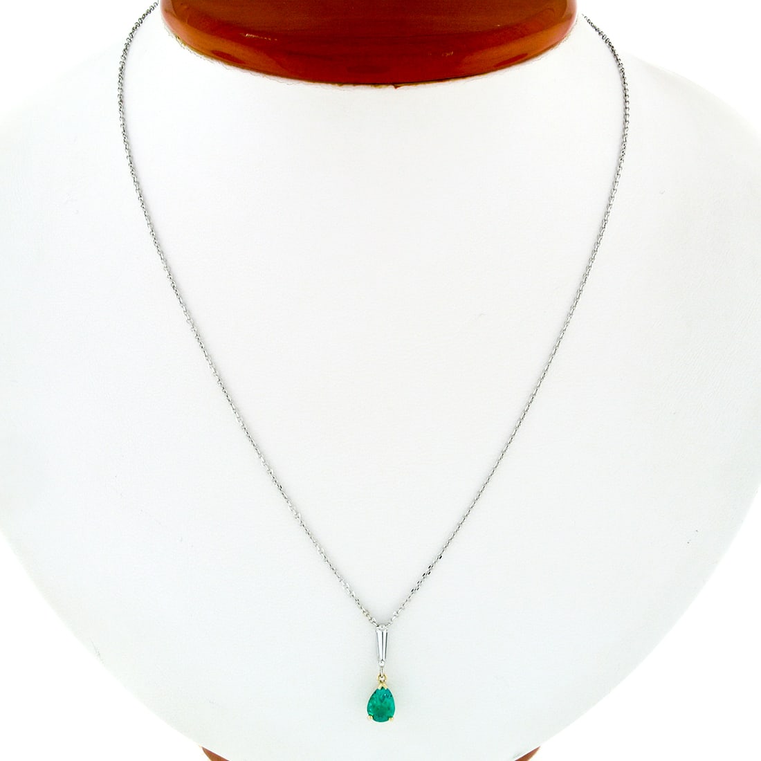 Petite 14K Two Tone Gold Emerald Diamond Drop Pendant 0.81ct: Petite 14K Two Tone Gold Emerald Diamond Drop Pendant 0.81ct This exquisite pendant features a stunning pear-shaped natural emerald, weighing 0.61 carats, beautifully complemented by a long tapered ba