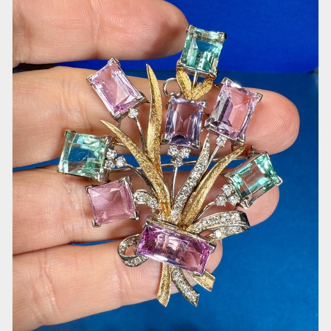 1960s 14K Yellow Gold Aquamarine Tourmaline Diamond Bouquet Brooch: 1960s 14K Yellow Gold Aquamarine Tourmaline Diamond Bouquet Brooch This stunning 1960's brooch is crafted from 14K yellow gold and features a beautiful bouquet design. It is adorned with three aquamar