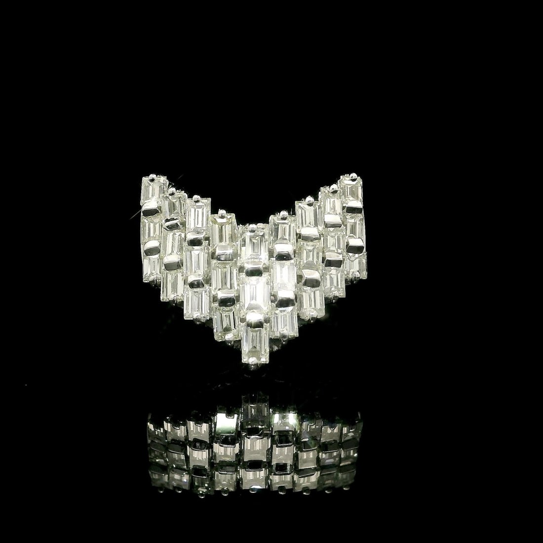 Platinum Wide Band Ring with 1.50ctw Baguette Diamonds Bar Set: Platinum Wide Band Ring with 1.50ctw Baguette Diamonds Bar Set This stunning wide band ring features a unique "V" chevron design, elegantly showcasing (27) natural baguette cut diamonds totaling appro