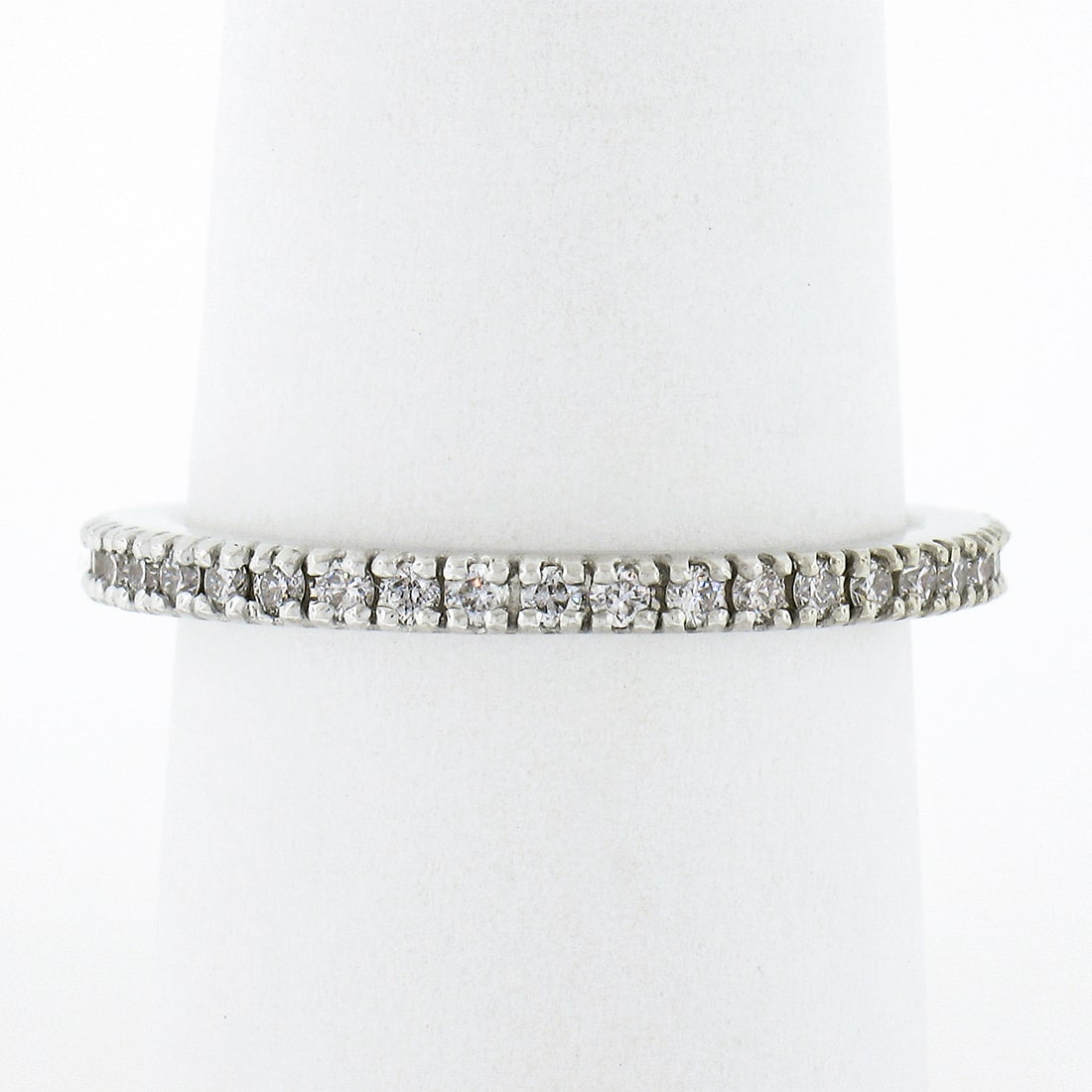 14k White Gold 0.55ctw Round Diamond Eternity Band Ring: 14k White Gold 0.55ctw Round Diamond Eternity Band Ring This exquisite eternity band ring is crafted from solid 14k white gold and showcases 40 dazzling round brilliant cut diamonds, elegantly prong s