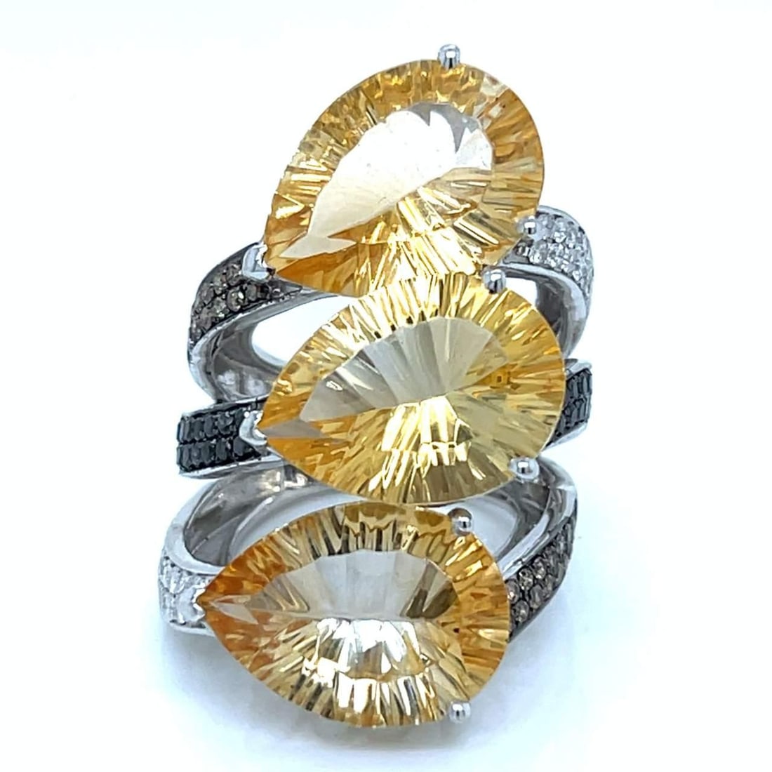 18k White Gold Citrine Diamond Ring 27 Ct Gemstone Trio: 18k White Gold Citrine Diamond Ring 27 Ct Gemstone Trio This stunning 18k white gold ring showcases a trio of vibrant citrine gemstones, totaling approximately 27.00 Ct., beautifully complemented by 1