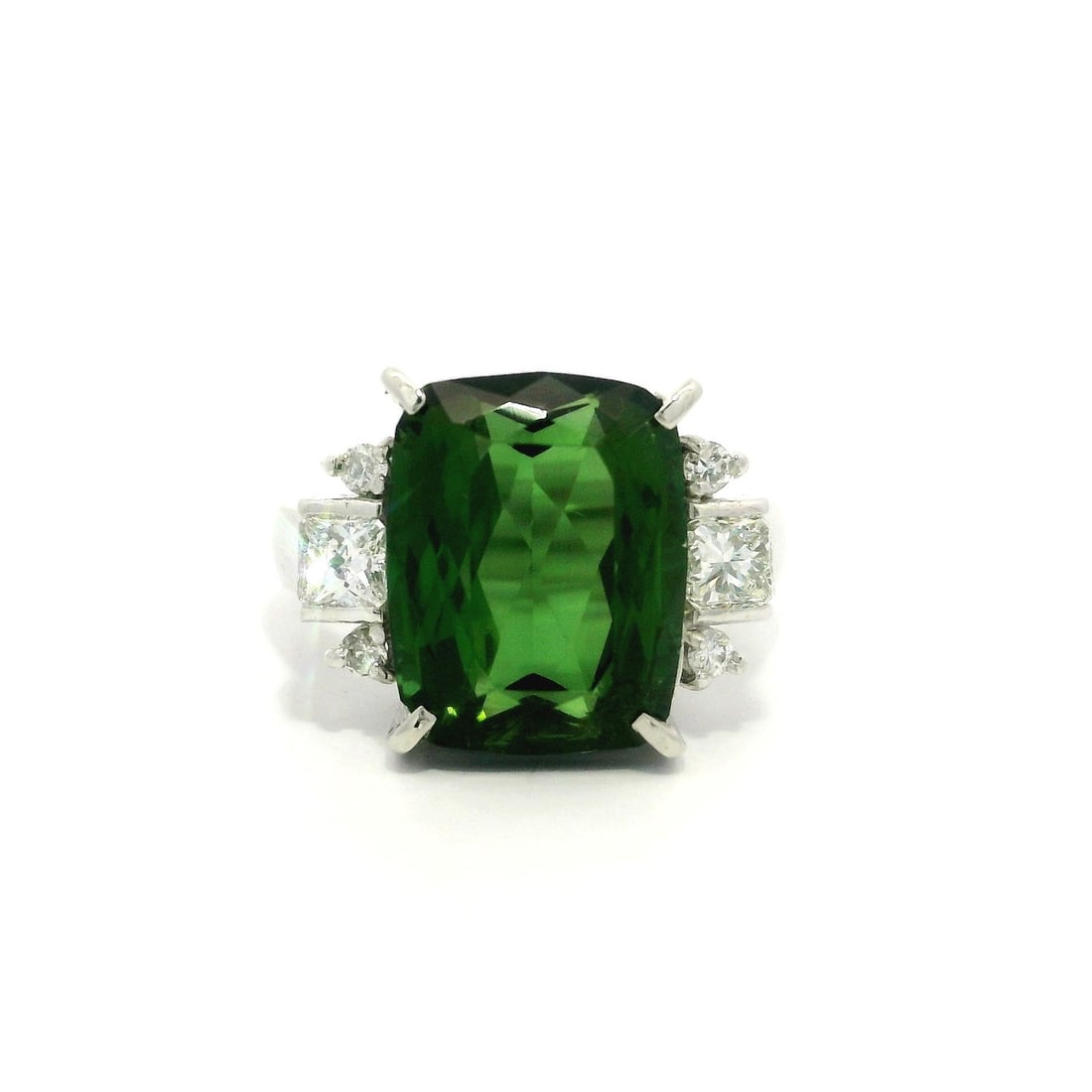 Platinum GIA 7.62ct Cushion Green Tourmaline Diamond Ring: Platinum GIA 7.62ct Cushion Green Tourmaline Diamond Ring This exquisite cocktail ring features a stunning natural cushion-cut green tourmaline, weighing 7.12ct, prong set to showcase its clean and vi
