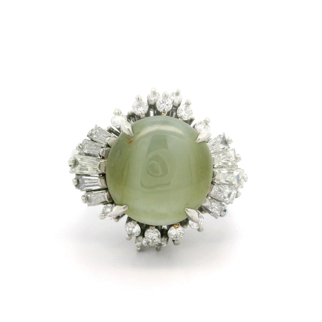 Platinum 8.69ctw Cabochon Cat's Eye Diamond Ballerina Ring: Platinum 8.69ctw Cabochon Cat's Eye Diamond Ballerina Ring This exquisite cocktail ring is crafted from solid platinum, featuring a stunning 7.86ct natural cabochon cat's eye in a yellowish green colo