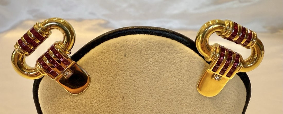 Elegant 18K Yellow Gold Ruby Diamond Huggie Stud Earrings: Elegant 18K Yellow Gold Ruby Diamond Huggie Stud Earrings This exquisite pair of huggie stud earrings showcases a stunning combination of 18k yellow gold, diamonds, and rubies, reflecting the elegance