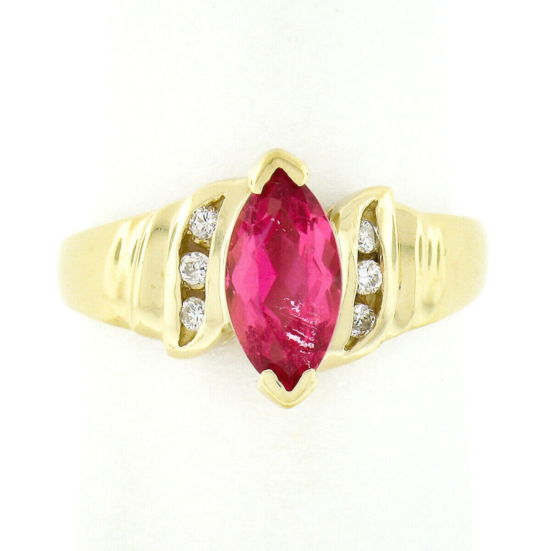14k Yellow Gold 1.00ct Marquise Pink Tourmaline Diamond Accent Ring: 14k Yellow Gold 1.00ct Marquise Pink Tourmaline Diamond Accent Ring This stunning ring features a radiant marquise cut pink tourmaline, beautifully set in solid 14k yellow gold. Weighing approximately
