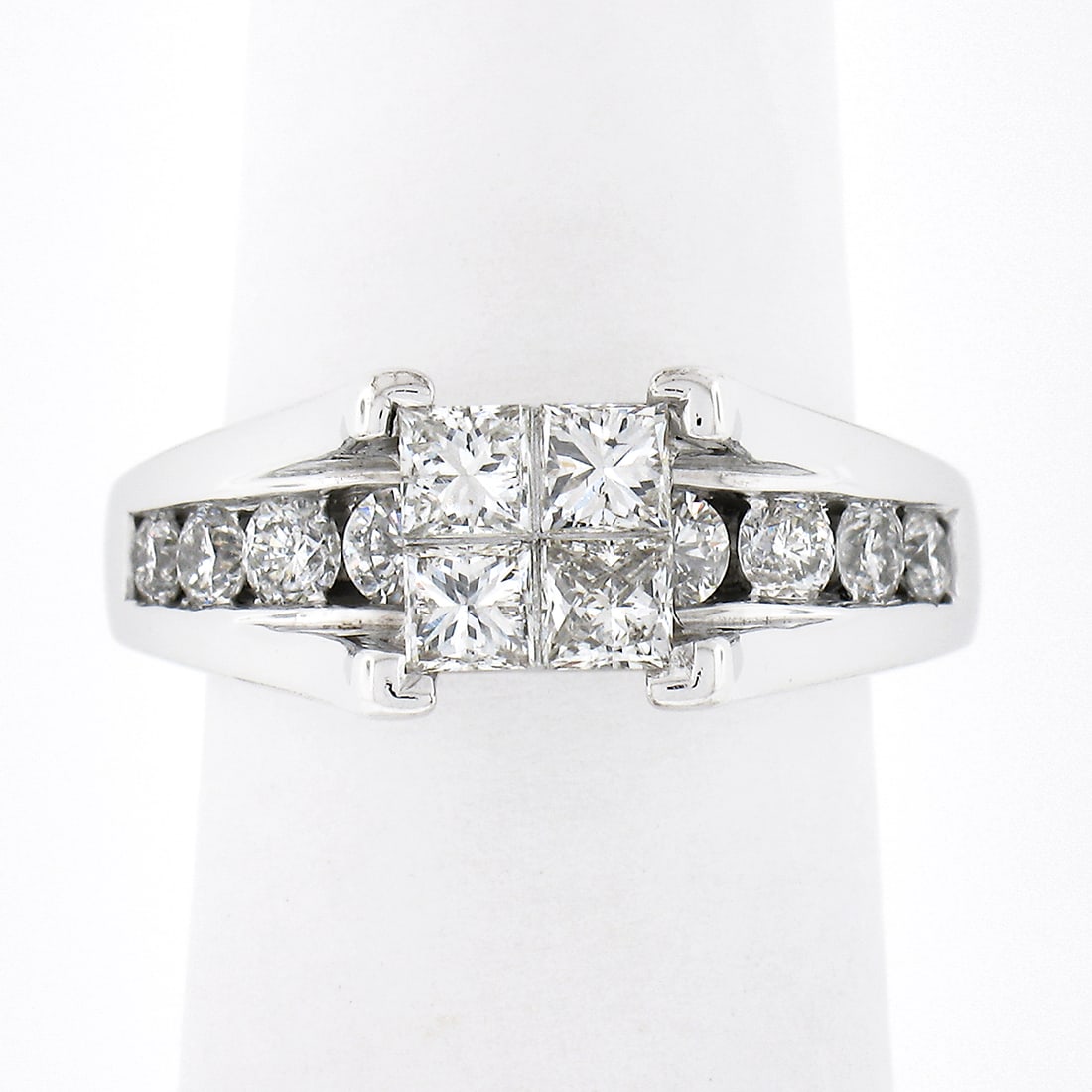 14K White Gold Engagement Ring with Invisible Set Princess Diamonds: 14K White Gold Engagement Ring with Invisible Set Princess Diamonds Elevate your engagement with this stunning 14K White Gold Invisible Set Princess Diamond Engagement Ring. This elegant ring features
