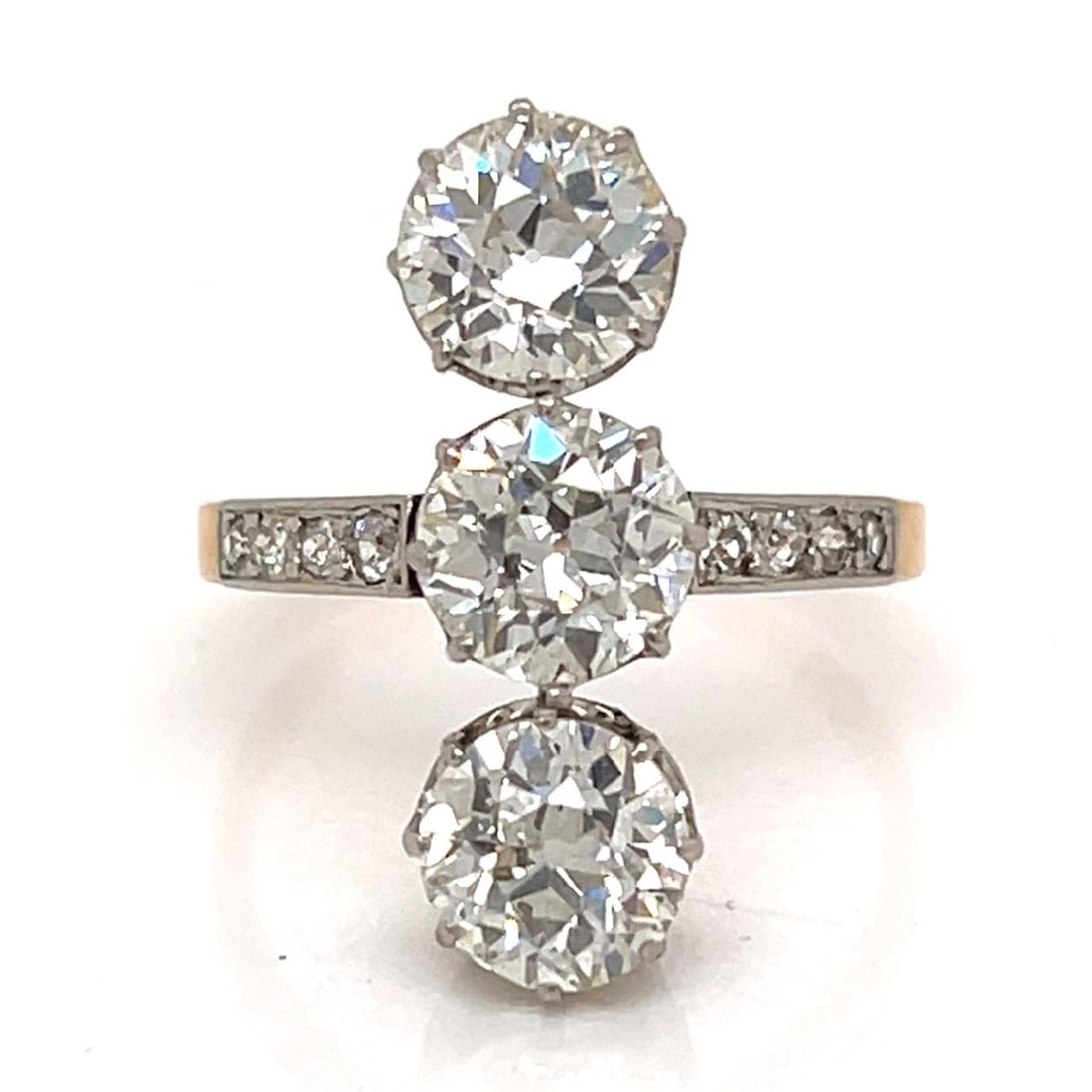 Three Stone Diamond Ring in 18K Gold and Platinum Victorian Era: Three Stone Diamond Ring in 18K Gold and Platinum Victorian Era This Victorian era ring is crafted from 18K gold with a platinum top and features a classic three-stone design. The ring is set with thr