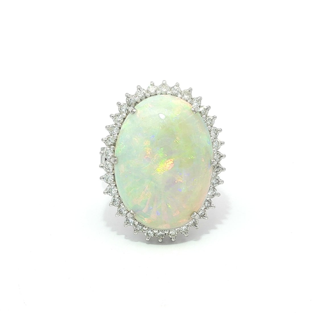 Vintage 14k White Gold 9.28ct Opal Diamond Halo Cocktail Ring: Vintage 14k White Gold 9.28ct Opal Diamond Halo Cocktail Ring This stunning vintage cocktail ring features a large natural opal at its center, displaying vibrant green and violet colors. The opal is a