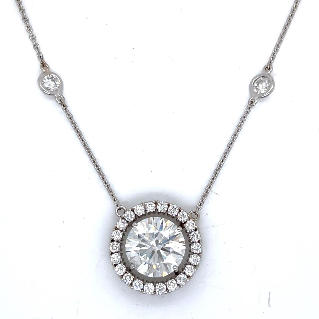 6.04 Ct GIA Diamond Pendant Necklace in 18K White Gold with 2.10 Ct Accents: 6.04 Ct GIA Diamond Pendant Necklace in 18K White Gold with 2.10 Ct Accents This elegant necklace features a GIA certified 6.04 carat round diamond set in 18K white gold. The primary diamond is graded