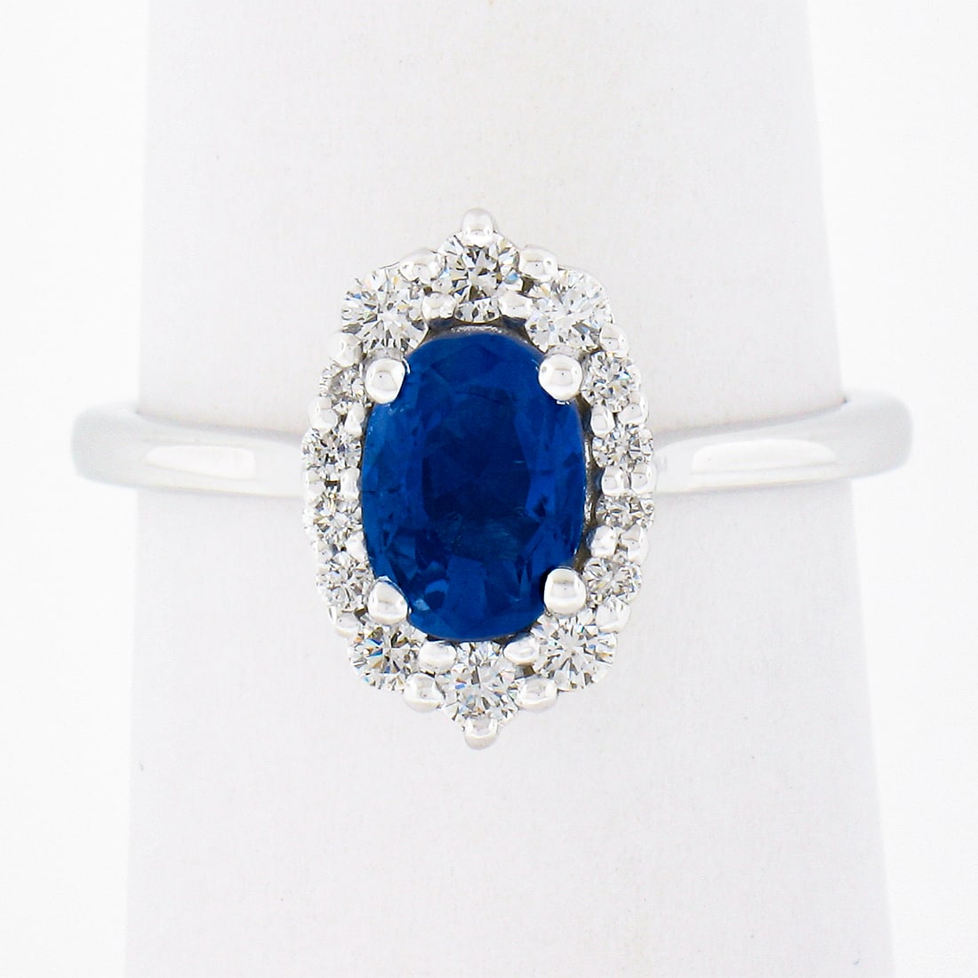 14K White Gold GIA Certified 1.58ct Halo Sapphire Diamond Engagement Ring: 14K White Gold GIA Certified 1.58ct Halo Sapphire Diamond Engagement Ring This exquisite engagement ring showcases a stunning GIA certified 1.28ct oval sapphire, set in luxurious 14K white gold. The s