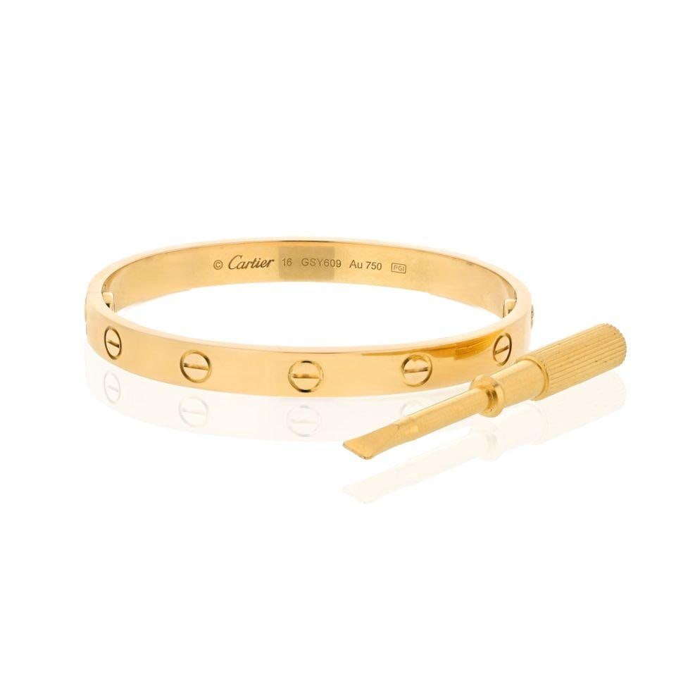 18K Yellow Gold Cartier Love Bracelet Size 16 with Screwdriver: 18K Yellow Gold Cartier Love Bracelet Size 16 with Screwdriver This Cartier Love bracelet is crafted from 18K yellow gold and features the iconic screw motif. It is a size 16 and comes with a screwdri