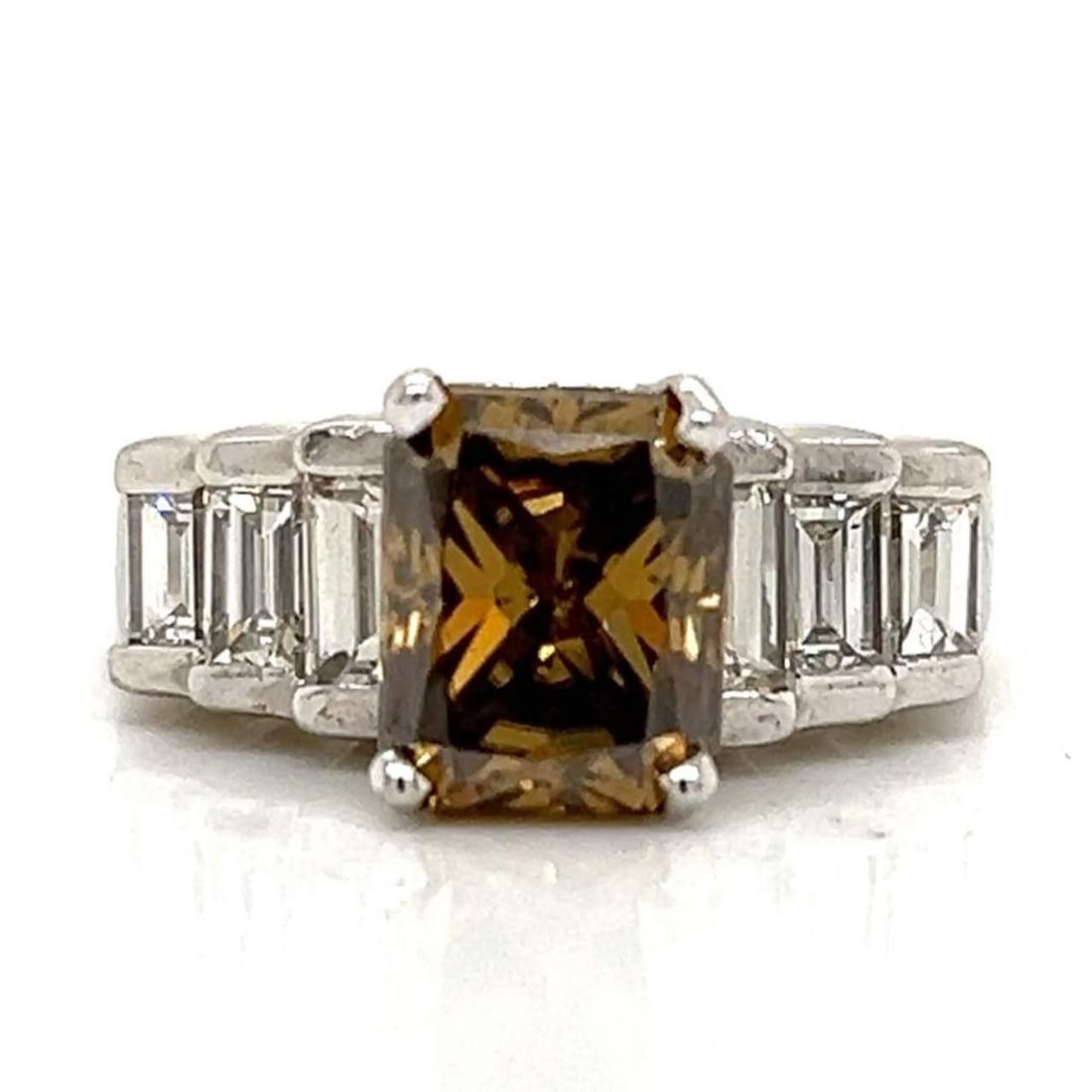 Platinum 2.69 Ct Champagne Diamond Engagement Ring with 6 Emerald Cuts: Platinum 2.69 Ct Champagne Diamond Engagement Ring with 6 Emerald Cuts This exquisite engagement ring features a stunning 2.69 ct emerald cut champagne diamond, beautifully set in luxurious platinum.