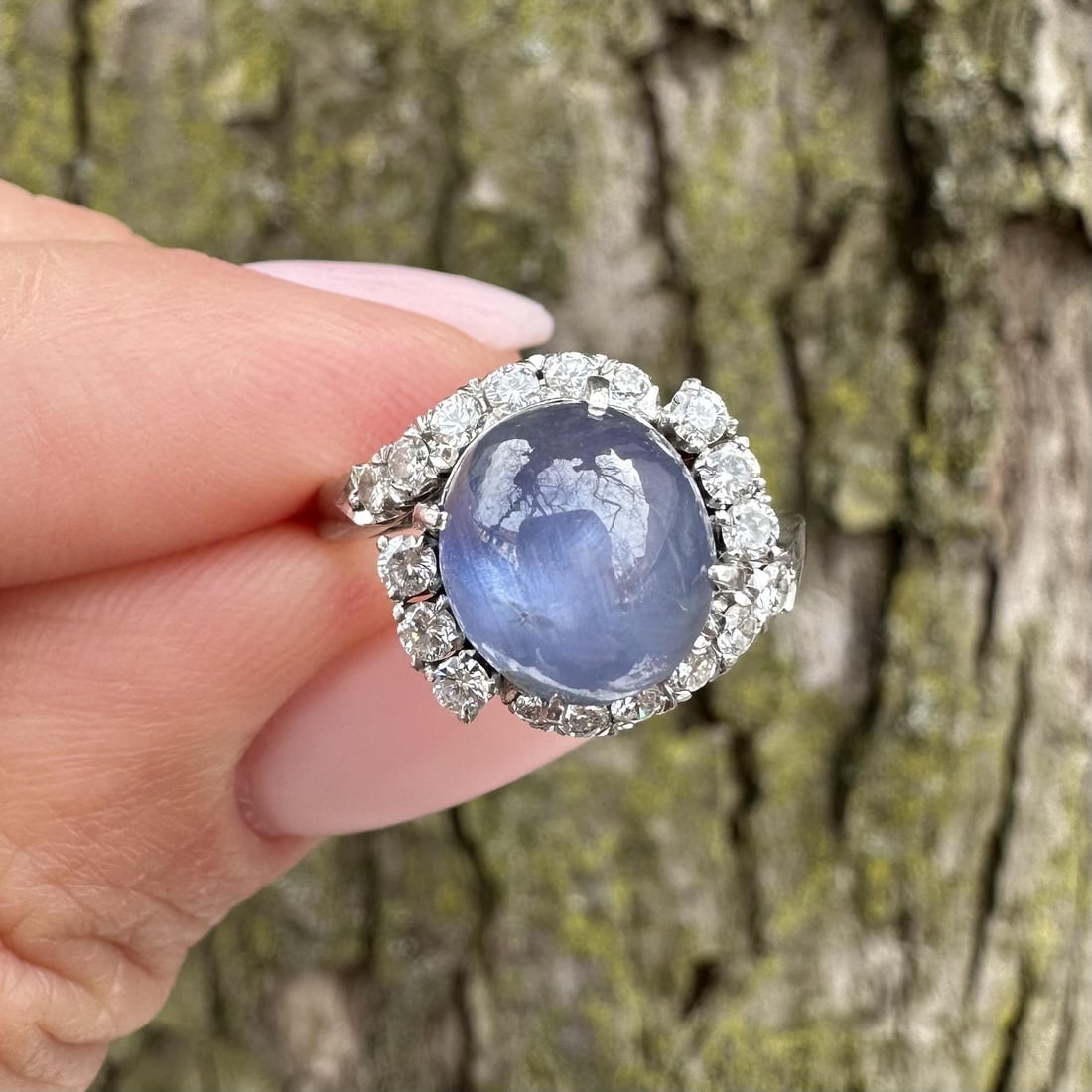 Platinum Ring with 5.25ct Blue Star Sapphire and Diamond Accents Vintage Bypass Design: Platinum Ring with 5.25ct Blue Star Sapphire and Diamond Accents Vintage Bypass Design This vintage bypass ring showcases a striking 5.25 carat natural star sapphire in an oval cabochon cut, displayin