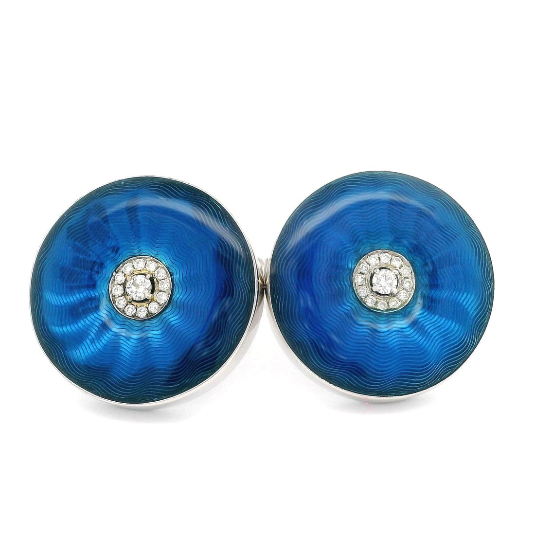 18k White Gold Blue Enamel Diamond Round Cufflinks: 18k White Gold Blue Enamel Diamond Round Cufflinks Elevate your formal attire with these exquisite cufflinks, crafted in solid 18k white gold. The vivid guilloche blue enamel work beautifully compleme