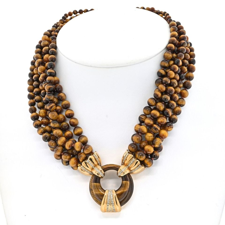14K Yellow Gold Diamond Tiger Eye Multi-Strand Necklace: 14K Yellow Gold Diamond Tiger Eye Multi-Strand Necklace The 14K Yellow Gold Tiger Eye Multi-Strand Bead Diamond Necklace is an exquisite piece that showcases six strands of uniquely patterned tiger ey