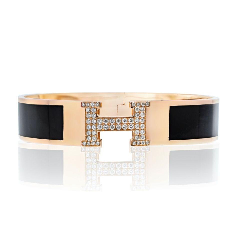 Hermes 18K Yellow Gold Clic Clac H Diamond Bracelet with Black Enamel: Hermes 18K Yellow Gold Clic Clac H Diamond Bracelet with Black Enamel The Hermes 18K Yellow Gold Clic Clac H Bracelet features a stunning design, crafted from luxurious 18K yellow gold with black enam