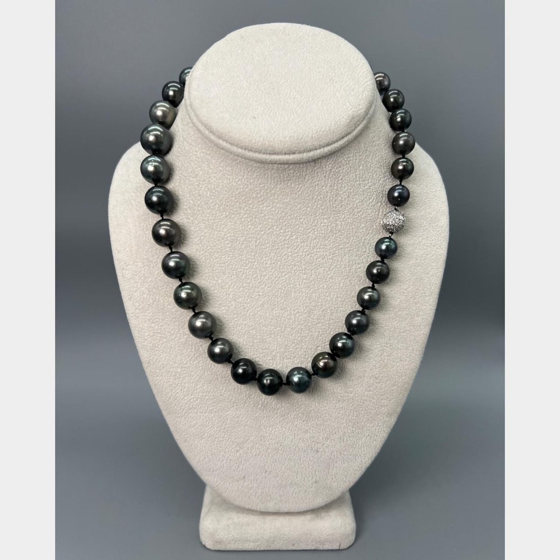 South Sea Black Pearl Strand Featuring 18K White Gold and Diamond Clasp: South Sea Black Pearl Strand Featuring 18K White Gold and Diamond Clasp This graduated black South Sea pearl necklace features pearls ranging from 13.9 mm to 10.0 mm, elegantly strung and secured with