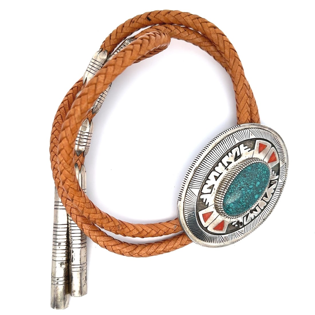 Large Turquoise Sterling Silver Navajo Bolo Tie with Braided Tan Leather: Large Turquoise Sterling Silver Navajo Bolo Tie with Braided Tan Leather This Gibson Nez Navajo bolo tie features a large, natural oval turquoise cabochon bezel set in sterling silver, accented with f