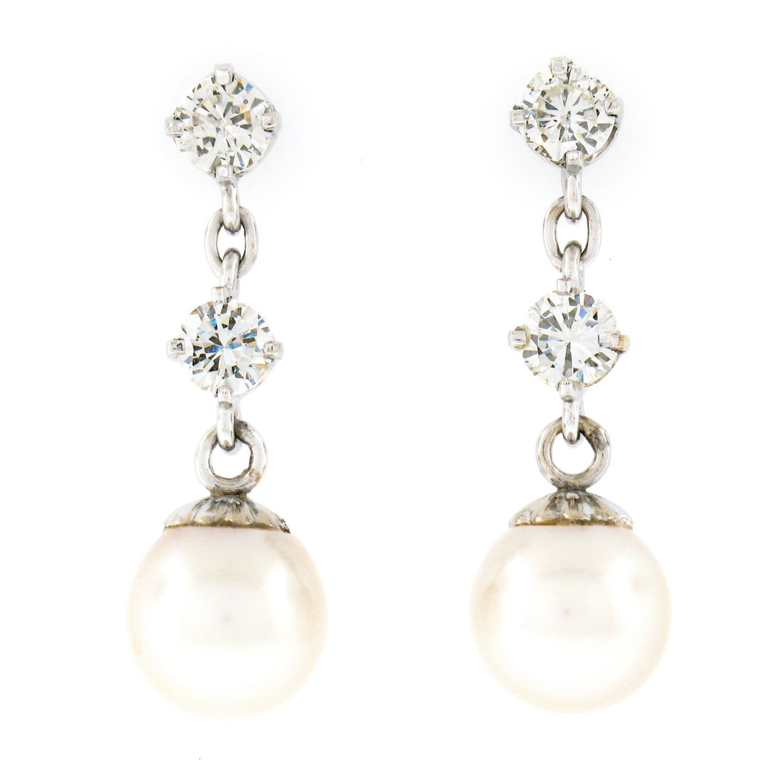 Vintage 14k White Gold Dangle Earrings with 0.72ctw Diamonds & 7.5mm Pearls: Vintage 14k White Gold Dangle Earrings with 0.72ctw Diamonds & 7.5mm Pearls These vintage earrings are crafted from solid 14k white gold, showcasing a total carat weight of approximately 0.72ctw. Each