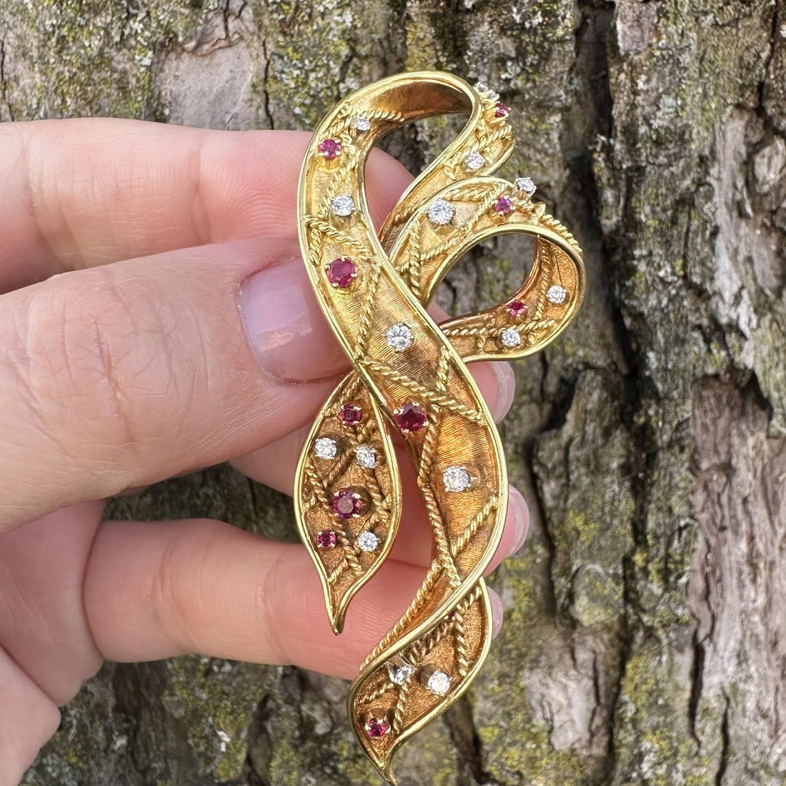 Handcrafted 18k Yellow Gold Ribbon Brooch with Diamonds and Rubies: Handcrafted 18k Yellow Gold Ribbon Brooch with Diamonds and Rubies This vintage ribbon pin brooch by Spritzer & Fuhrmann is hand made from solid 18k yellow gold. It features 15 natural round brilliant