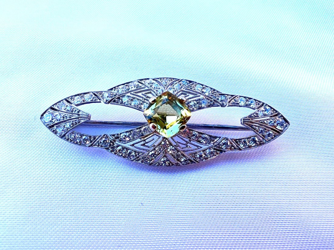 French Art Deco Platinum Diamond Chrysoberyl Brooch with GIA Certificate: French Art Deco Platinum Diamond Chrysoberyl Brooch with GIA Certificate Experience the elegance of this exquisite French Art Deco brooch, crafted in luxurious platinum with a stunning diamond chrysob